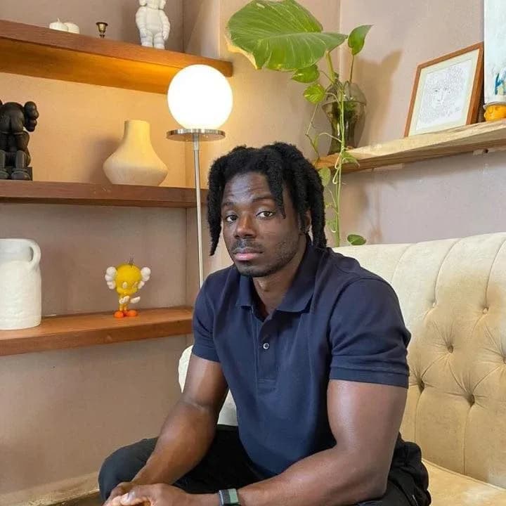 Alex, personal trainer and soccer coach, seated in a navy polo shirt