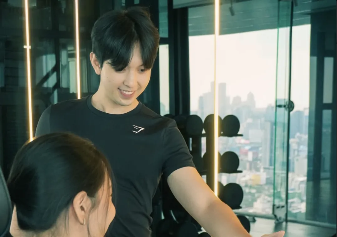 A FlexiFit trainer coaching a client in a condo gym